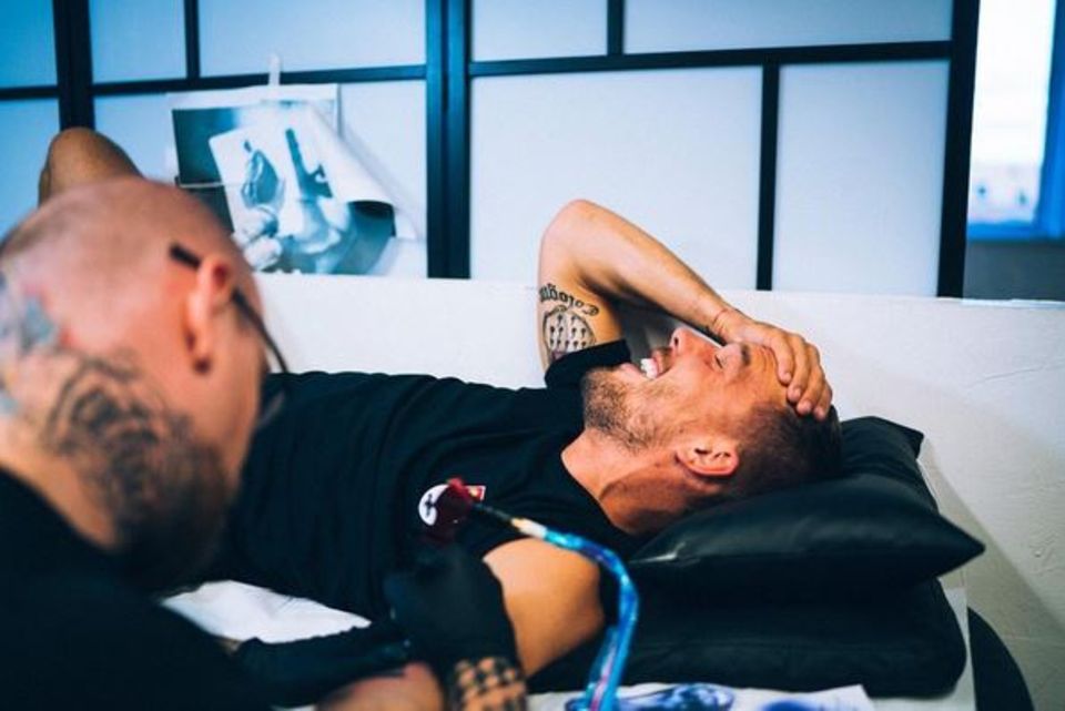 Beim Tätowierer kann es ganz schön schmerzhaft werden: Lucas Podolski versucht stark zu bleiben. Beim Tätowierer kann es ganz schön schmerzhaft werden: Lucas Podolski versucht stark zu bleiben.