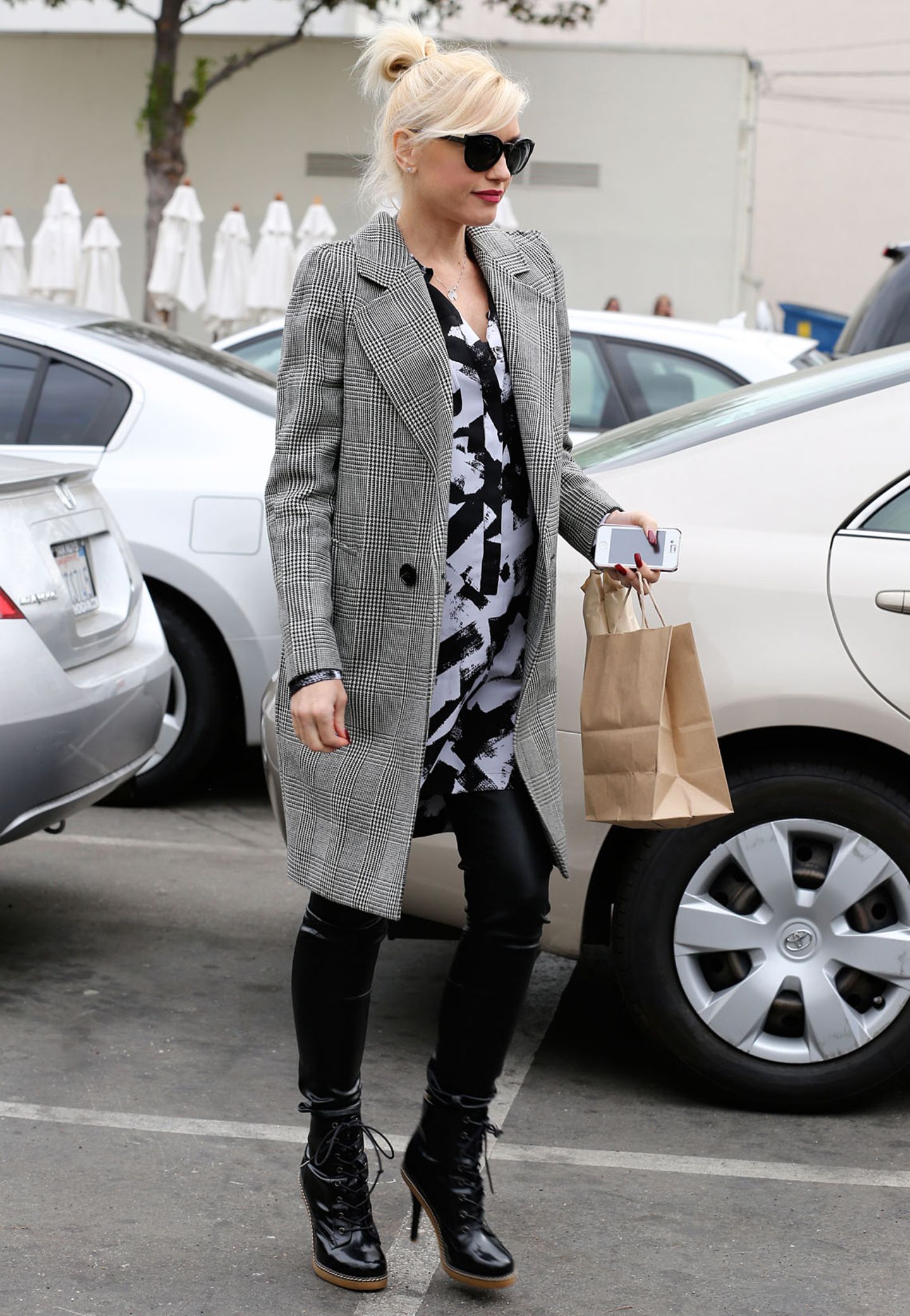 Mustermixe funktionieren bei Gwen Stefani immer gut: Den karierten Mantel kombiniert sie mit einem schwarz-weißen, langen Hemd.