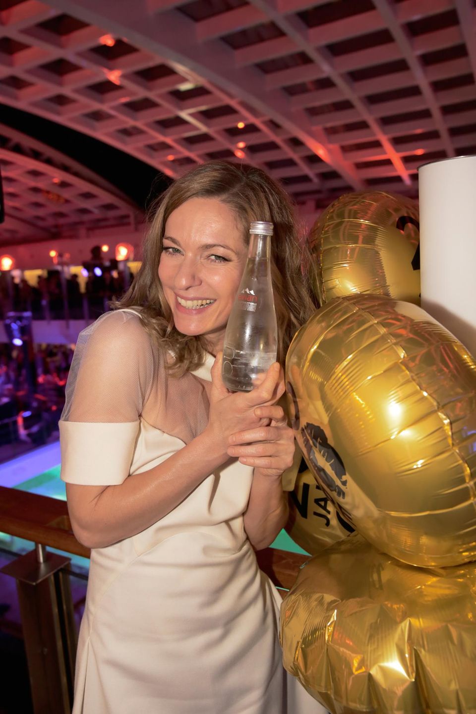Lisa Martinek kühlt sich auf der Party die Hände an einer kühlen Flasche Wasser von Sponsor "Evian". Lisa Martinek kühlt sich auf der Party die Hände an einer kühlen Flasche Wasser von Sponsor "Evian".