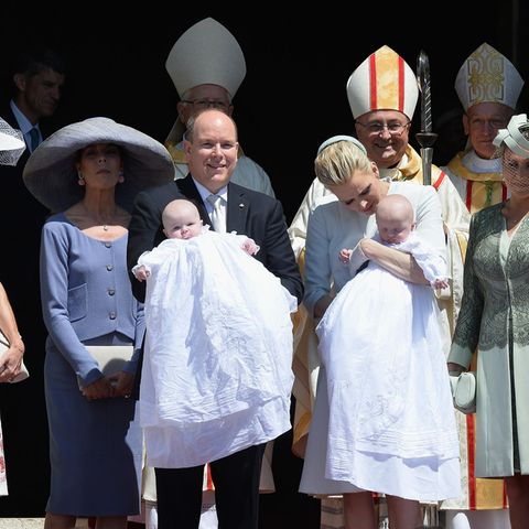 Für die Taufe von Prinz Jacques und Prinzessin Gabriella von Monaco am 10. Mai 2015 trägt Fürstin Charlène Weiß. Dazu sehr elegant ihre sommerlichen Handschuhe. Prinzessin Caroline kommt mit großem Hut, auffälligen Ohrringen und lilafarbenem Kostüm.