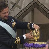 Taufpate Prinz Carl Philip füllt das Taufbecken mit Wasser aus einer Quelle auf Öland.