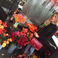 Cathy Hummels: Rote Rosen dürfen in der Stadt der Liebe nicht fehlen. Und diese passen sogar farblich zur Chanel-Bag in Lack-Optik.