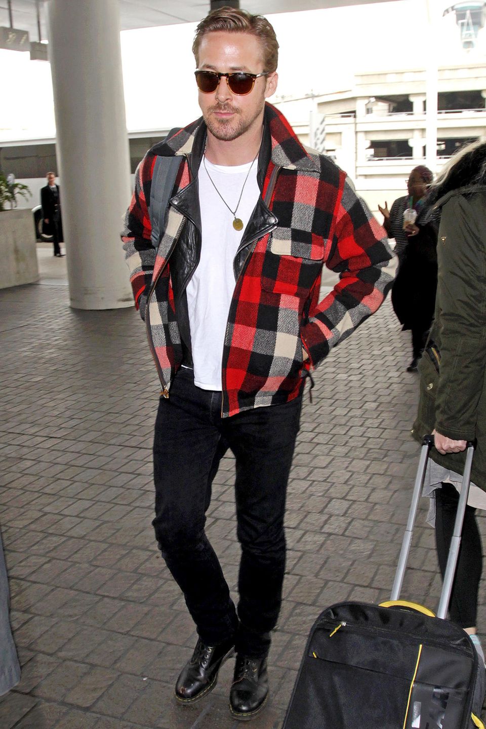 Rocker? Baumfäller? Auf jeden Fall hot! Ryan Gosling kombiniert sein schwarz-weißes Rockeroutfit und Lederjacke mit der karierten Wolljacke.
