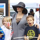 Ja, finden wir auch, Knox, dieser Look ist echt zum Schreien. Mama Angelina Jolie sieht beim Flohmarktbummel mit ihren Kids so aus, als hätte sie sich die knielange, graue Strickjacke nur schnell über das schwarze Spitzen-Nachthemd geworfen, Schlapphut und schwarz-goldenen Slipper machen den Schlabber-Look perfekt. 