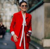 In voller Vorfreude begibt sich Olivia Palermo zu der Show von Dior und strahlt dabei mit ihrem roten Anzug um die Wette.