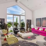 Eines der zahlreichen Wohnzimmer des Hauses ist recht farbenfroh gestaltet. Die pinke Couch, sowie die Teppiche im Animalprint sind wahre Hingucker. 