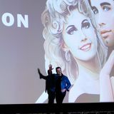 Hollywoodstar John Travolta  winkt den Zuschauern zu. Am Strand von Cannes wird sein Klassiker "Grease" aufgeführt. Mehr als genug Grund zum Anlass gibt es, schließlich ist der Kultfilm 40 Jahre alt geworden.