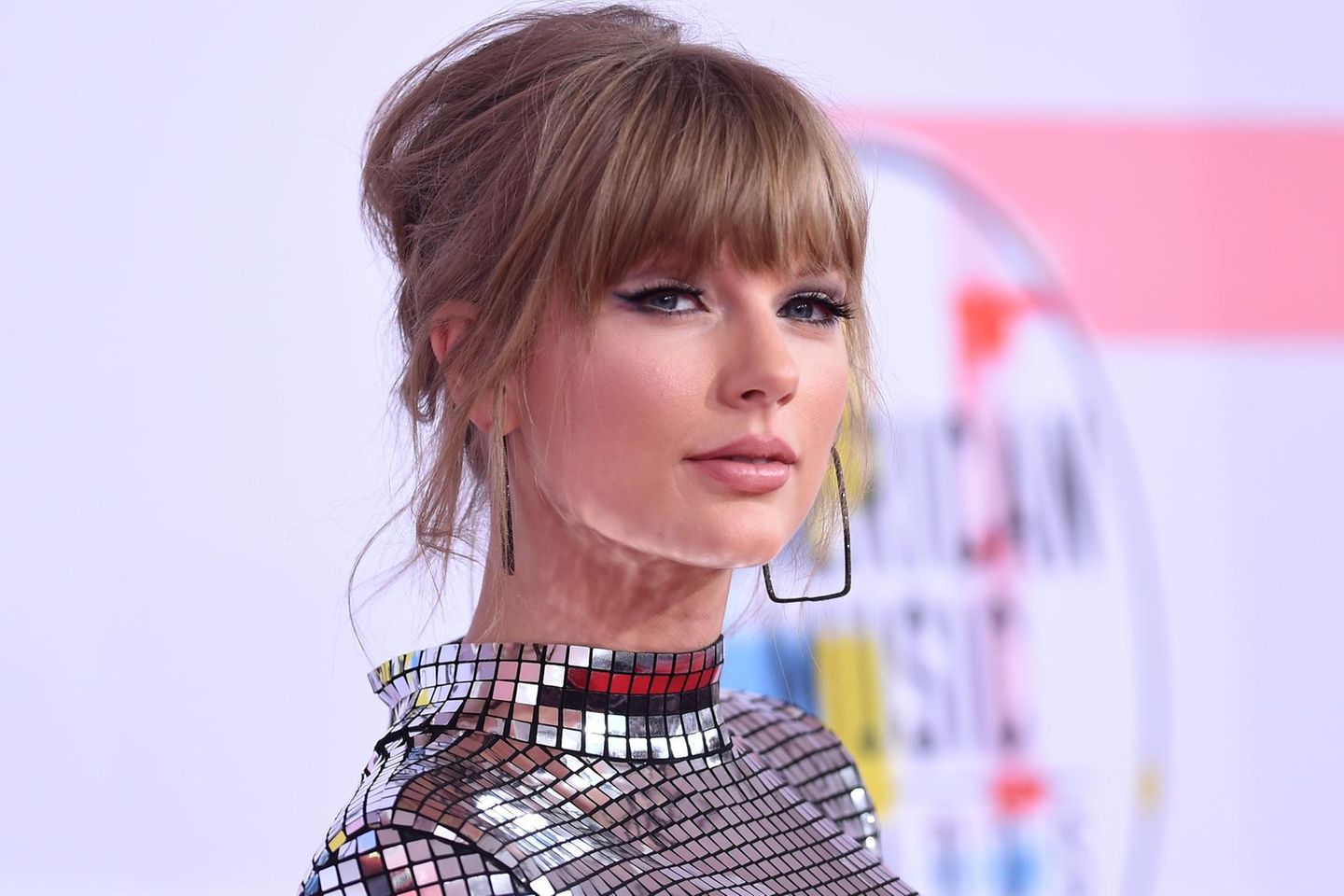 Taylor Swifts Kleid funkelt wie eine Discokugel, ihre Partyfrisur bleibt deshalb eher zurückhaltend.