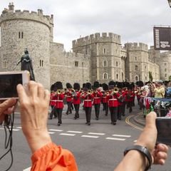 Zuschauer fotografieren die Wachablösung vor dem Windsor Castle, während innen der kleine Archie getauft wird.