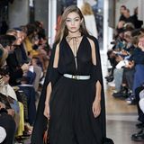 Auch ihre Schwester Gigi Hadid läuft für das Kultlabel Lanvin. Das schwarze, bodenlange Kleid besticht durch ein Cape am Rücken und ein tiefes V-Dekolleté. Volants am Saum perfektionieren auch diese Traum-Robe. 