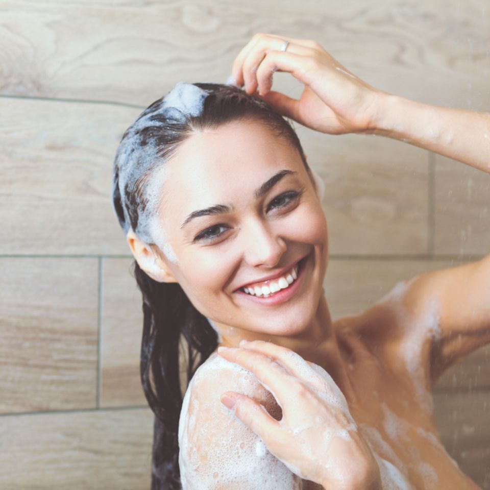 Shampoo ohne Silikone: Frau wäscht sich die Haare