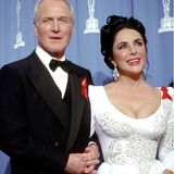 Nicht nur an der Stylefront war Schauspielerin Elizabeth Taylor eine absolute Vorreiterin. Zu den Oscars 1993 erscheint die Schauspielerin gemeinsam mit Paul Newman. Beide tragen eine große rote Schleife, um auf die Krankheit AIDS aufmerksam zu machen. Elizabeth Taylor gehörte zu den ersten AIDS-Aktivist:innen Hollywoods und erhielt dafür 1993 den "Jean Hersholt Humanitarian Award".