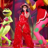 Skurril und trotzdem elegant performt Katy Perry bei ihrer "PLAY"-Show in Las Vegas im Resorts World Theatre. Das Konzert ist mit einem aufwendigen Bühnenbild ausgestattet. Neben Fliegenpilzen, riesigen Masken und Trinkdosen fallen aber vor allem die Looks der Sängerin auf. Der rote Lack-Body mit Cut-Outs allein ist schon ein besonderes Kleidungsstück, aber in Kombination mit den roten fransigen Lack-Chaps ist dieser Look wirklich ein Hingucker. Der Fliegenpilz-Hut rundet das Outfit ab und zeigt, wie abgestimmt die Sängerin mit ihrem Bühnenbild ist. Auch die anderen Looks harmonieren perfekt mit den Requisiten.