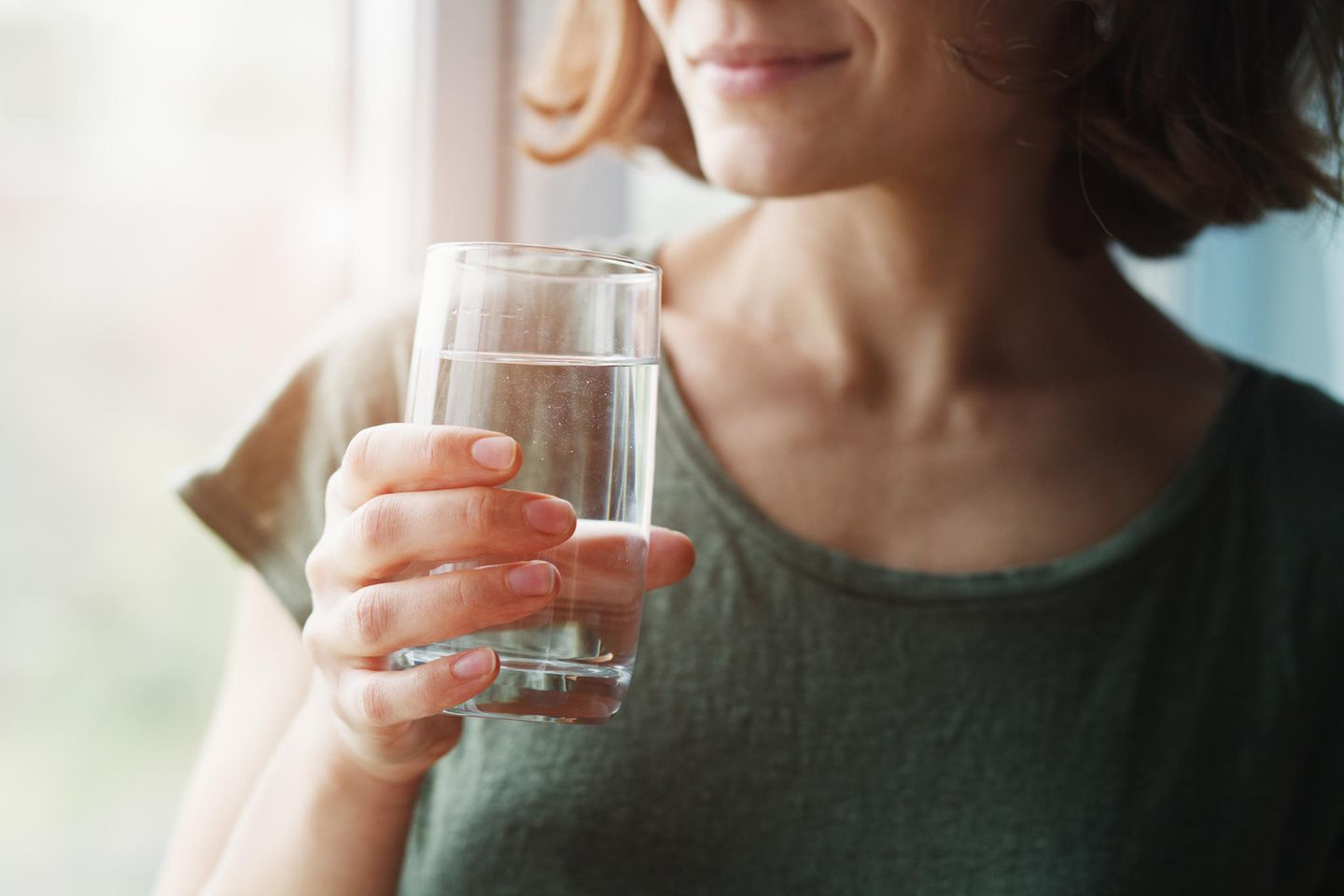 Frau mit Wasser: 5 Gründe, warum Sie morgens als Erstes ein Glas Wasser trinken sollten