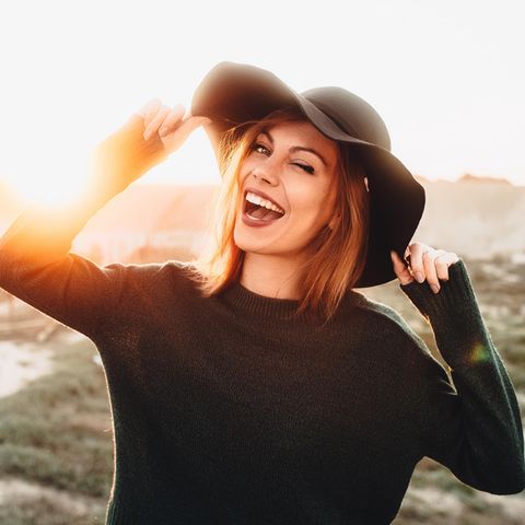 Glücklich lachende Frau in der Natur: Die 5 Gehirn-Typen und wie sie unser Glücksempfinden beeinflussen