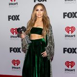 Auf dem Red Carpet der iHeartRadio Music Awards erscheint Jennifer Lopez in einem smaragdgrünen Zweiteiler aus Samt. In Kombination mit einer Seidenrobe im Leo-Print bekommt ihr Outfit einen Hauch Lässigkeit. Leichte Wellen in den Haaren runden den Look ab.