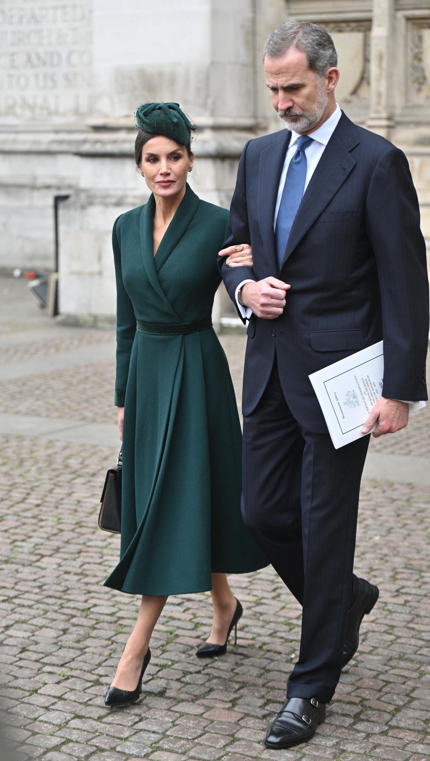Zur Trauerfeier von Prinz Philip wählt auch Königin Letizia ein dunkelgrünes Outfit: Das taillierte Mantelkleid kombiniert sie mit einem passenden Hut, schwarzen Pumps von Manolo Blahnik in Schlangenleder-Optik sowie einer schwarzen Tasche von BOSS. Mit dem grünen Look scheint sie sich auch dem Kleid der Queen angepasst zu haben. Sie trägt ebenfalls dunkelgrün.