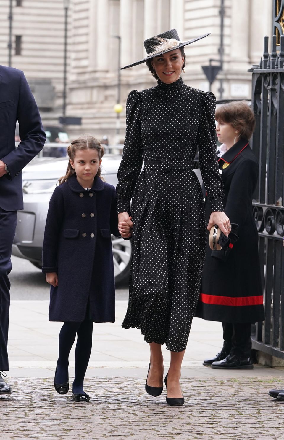 Duchess Catherine and Princess Charlotte holding hands on their way to Westminster Abbey