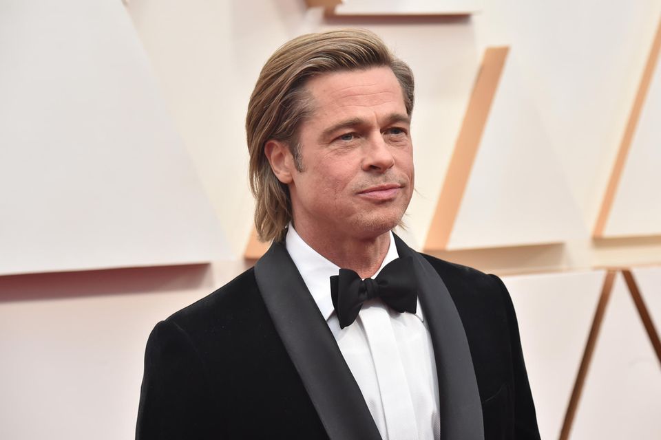 Brad Pitt posiert auf dem roten Teppich.