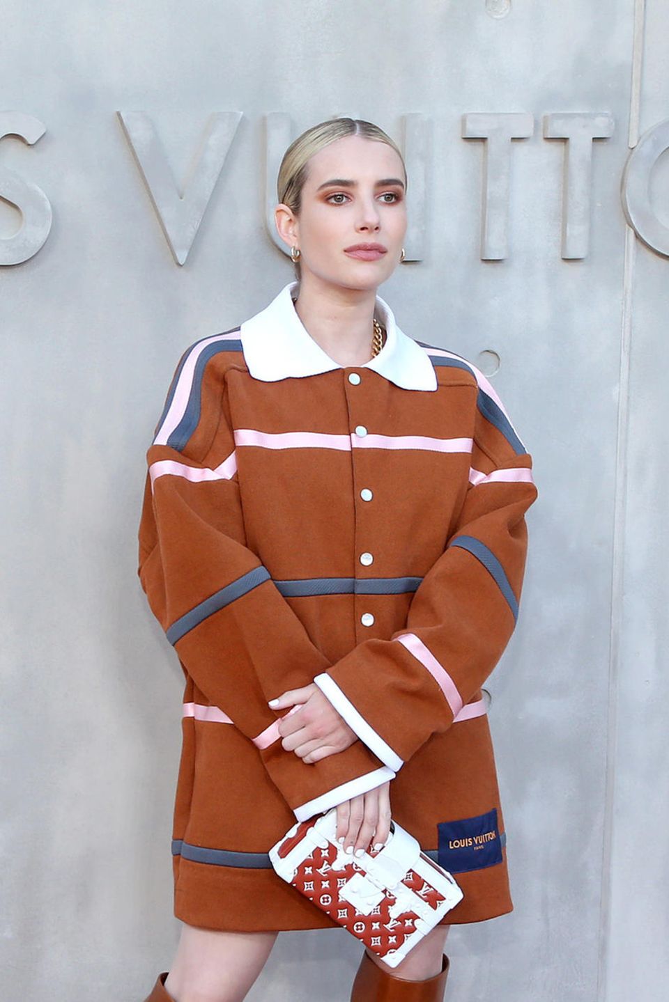 Emma Roberts erschien in einem cognacfarbenen Kurzmantel mit weißem Kragen und Streifen. Die Haare hatte sie in einem strengen Mittescheitel gestylt, toppt ihren Look mit einer kleine Koffer-Tasche des Labels. Emma Roberts erschien in einem cognacfarbenen Kurzmantel mit weißem Kragen und Streifen. Die Haare hatte sie in einem strengen Mittescheitel gestylt, toppt ihren Look mit einer kleine Koffer-Tasche des Labels.