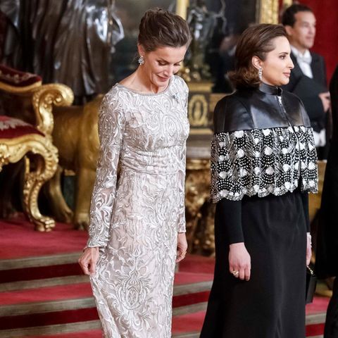 In Madrid wird die katarische Königsfamilie von König Felipe und Königin Letizia von Spanien zum Gala-Dinner empfangen. Für den Besuch beeindruckt uns Letizia wieder einmal mit ihrem Look: Sie trägt ein langes silberfarbenes Kleid, das mit glänzender Spitze besetzt ist und durch transparente Trompeten-Ärmel verzaubert. Mit ihrer Frisur betont sie zusätzlich ihre funkelnden Ohrringe.