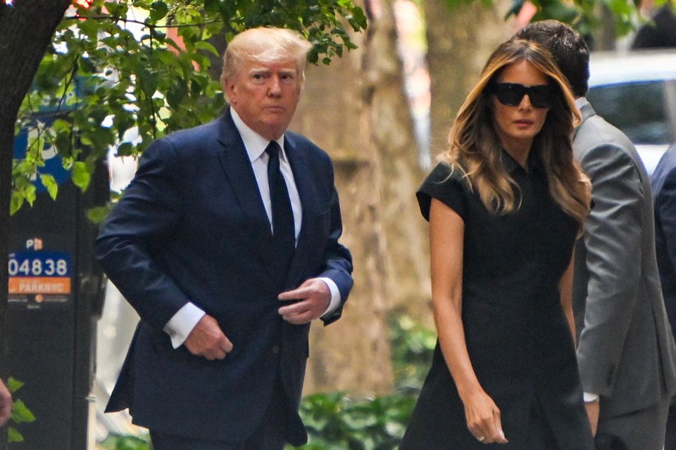 Donald and Melania Trump enter the church where Ivana Trump's funeral is taking place, a little late, through a side entrance.