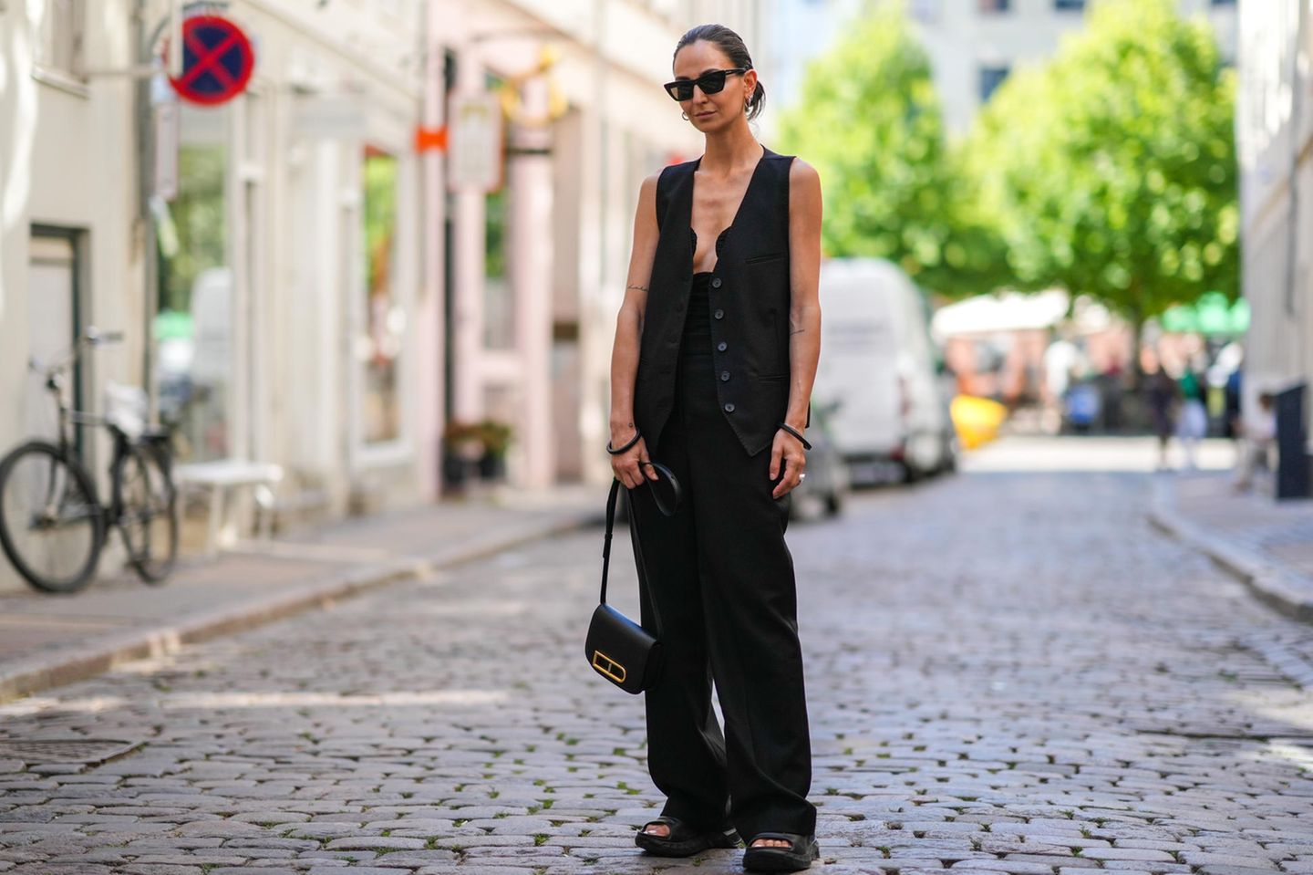 Die perfekte schwarze Hose: Frau trägt schwarze Hose und Weste