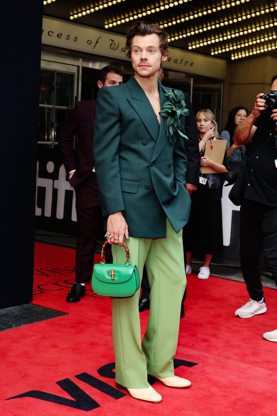 Auch Harry Styles sorgt für einen tollen Fashion-Moment in Toronto: Seinen dunkelgrünen Zweireiher kombiniert er mit hellgrüner Hose, als Accessoires trägt er eine üppige Federbrosche und die farblich perfekt passende "Bamboo 1947" Handtasche von Gucci, nicht ganz preiswert zu haben für rund 3.200 Euro. Und wer ganz genau hinsieht, erkennt auch seine grün lackierten Nägel.