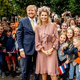 Ein feenhafter Aufritt der niederländischen Königin. In einem taupefarbenen Outfit verzaubert Königin Máxima die Gemeinde von Gemert-Bakel in Noord-Brabant. Ihr hinreißender Look besteht aus einem knielangen Kleid mit Ballonärmeln. Besonders auffällig ist jedoch ihr gigantischer Blumen-Kopfschmuck. Begeistert blicken die Kinder und Eltern zu der hoheitlichen Schönheit. 