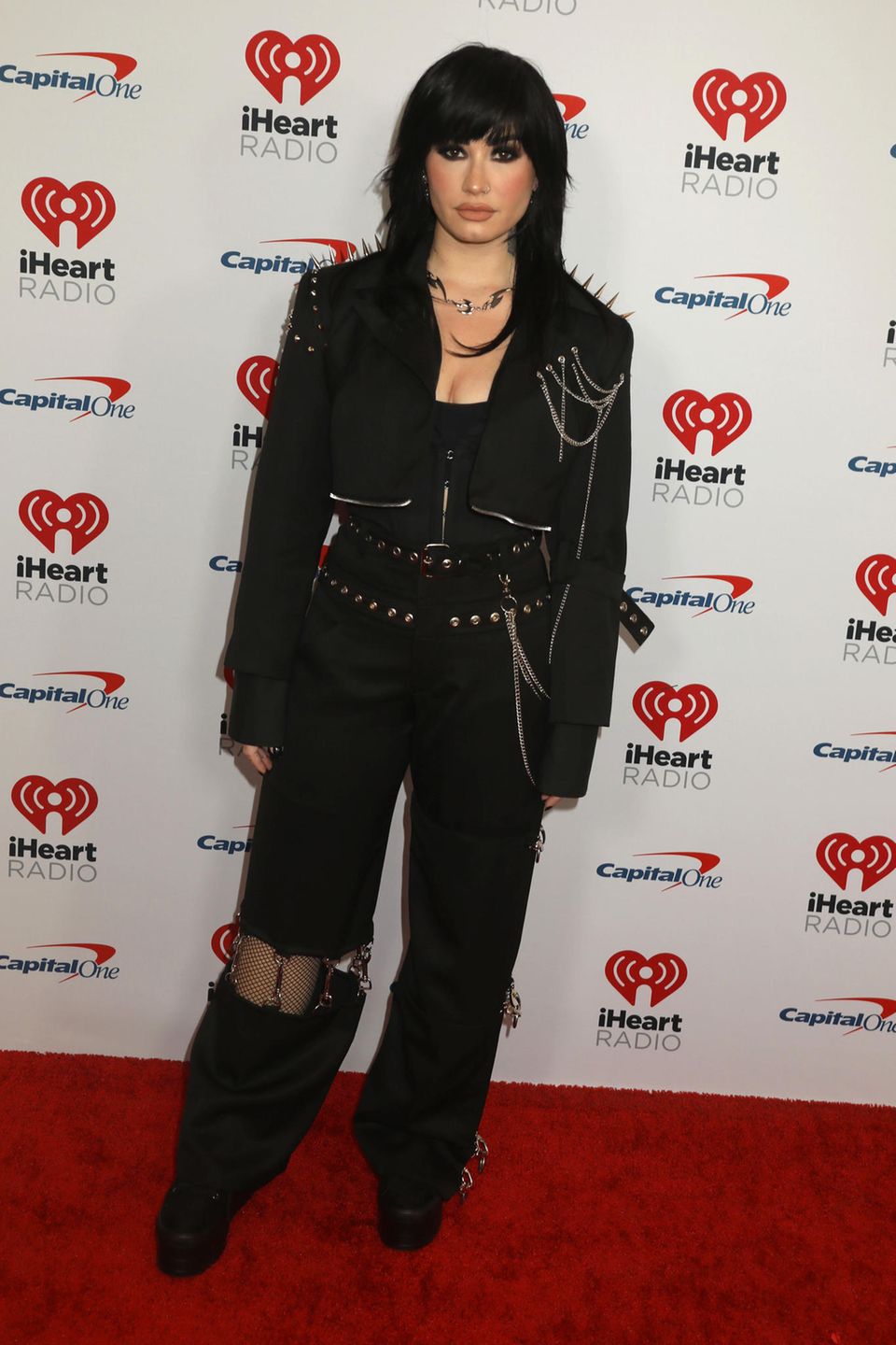 Demi Lovato setzt auf den angesagten Goth-Glam-Trend und zeigt sich in einem schwarzen Look mit Nieten und Ketten-Elementen.