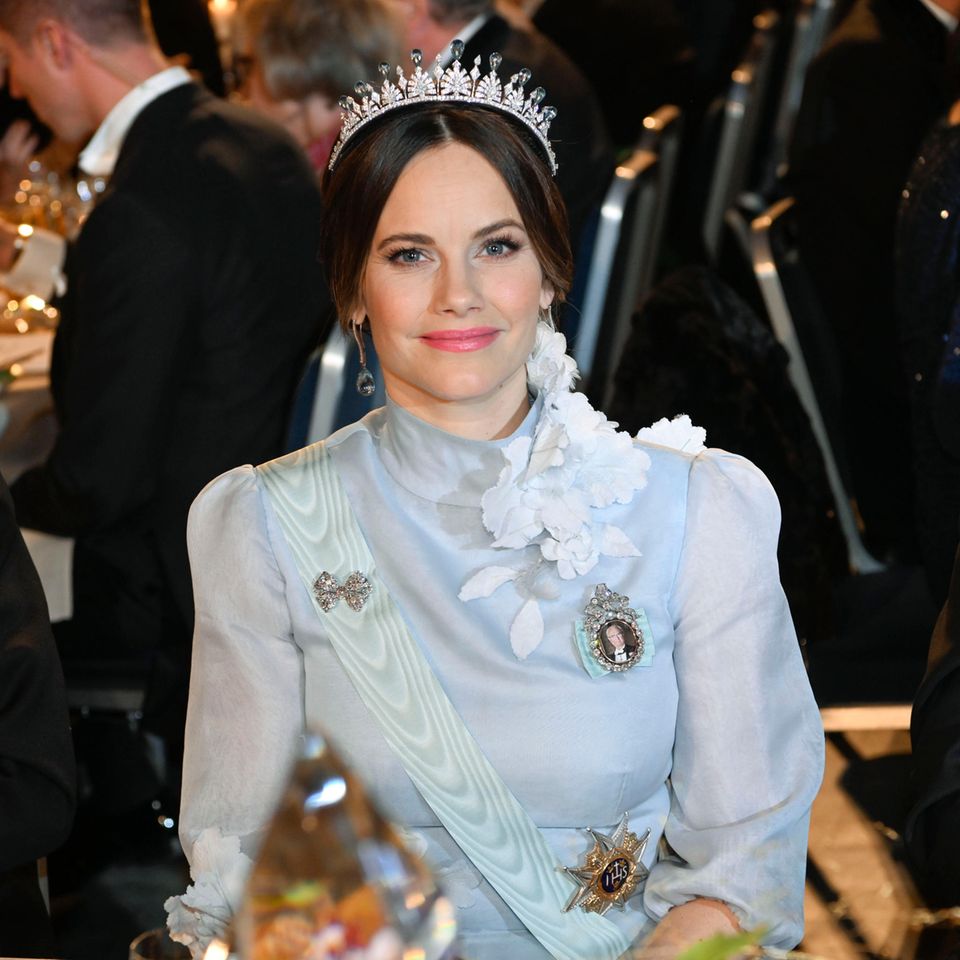Dazu trägt sie ihr Lieblingsstück, das Palmetten-Diadem, dieses Mal mit blassblauen Steinen. Die Steine sind nämlich austauschbar. Dazu trägt sie ihr Lieblingsstück, das Palmetten-Diadem, dieses Mal mit blassblauen Steinen. Die Steine sind nämlich austauschbar.