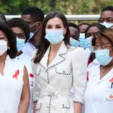 Königin Letizia zeigt sich bei ihrem Besuch eines Entbindungskrankenhauses ganz in Weiß. Das Leinen-Ensemble mit Schleifengürtel zieht alle Blicke auf sich, daher trägt Letizia nur einen schmalen goldenen Ring zu diesem sommerlichen Outfit.