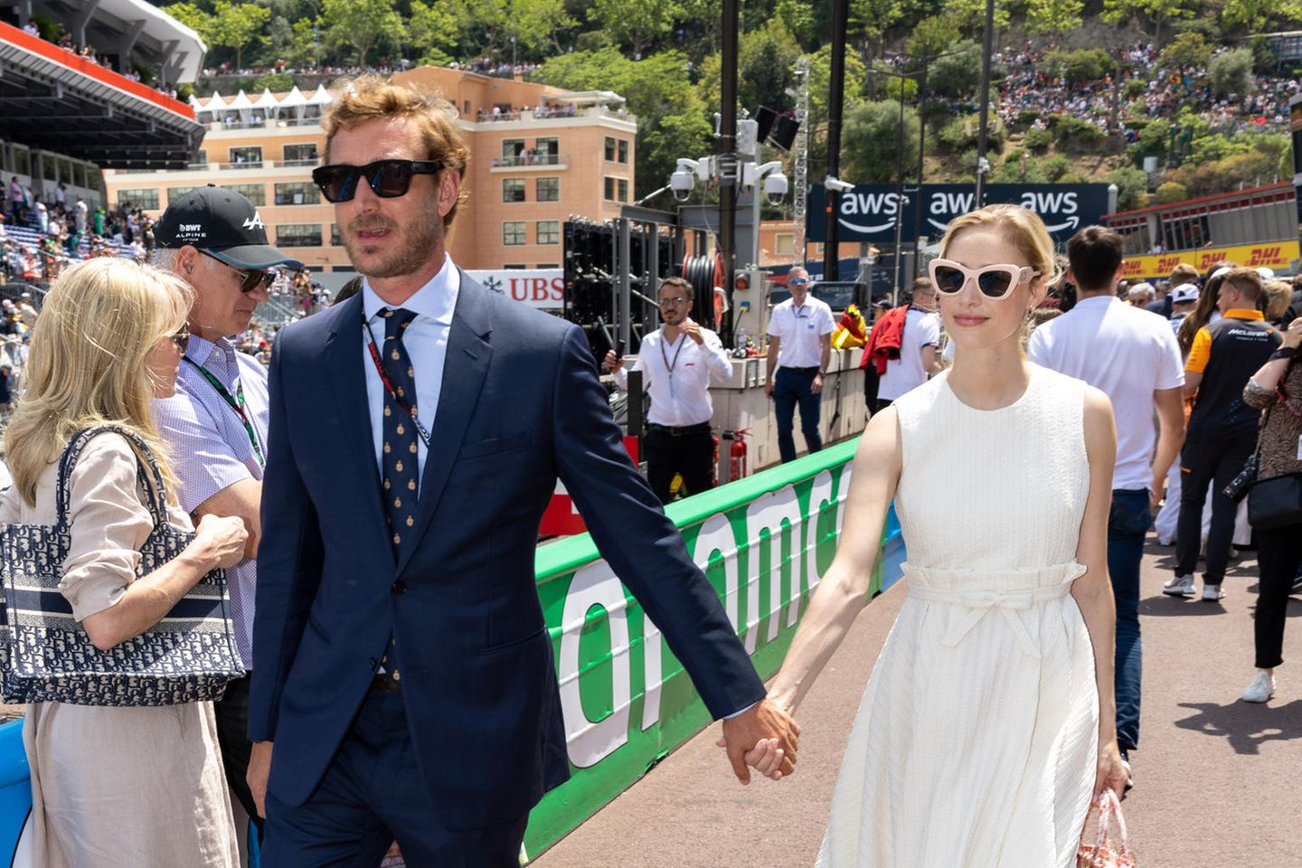 Ein Glamour-Paar wie es im Buche steht: Beatrice Borromeo und ihr Mann Pierre bringen Old-Hollywood-Vibes zur Rennbahn. Während der in einem klassischen Anzug mit Krawatte das Sport-Event besucht, setzt Beatrice auf ein weißes Dior-Dress mit plissiertem Unterteil und Taillengürtel. Das Muster ihrer Lady D-Lite Bag in Medium greift das Korallrot ihrer Slippers von Flabelus (für ca. 80 Euro) auf und sorgt damit für einen tollen Farbtupfer. 