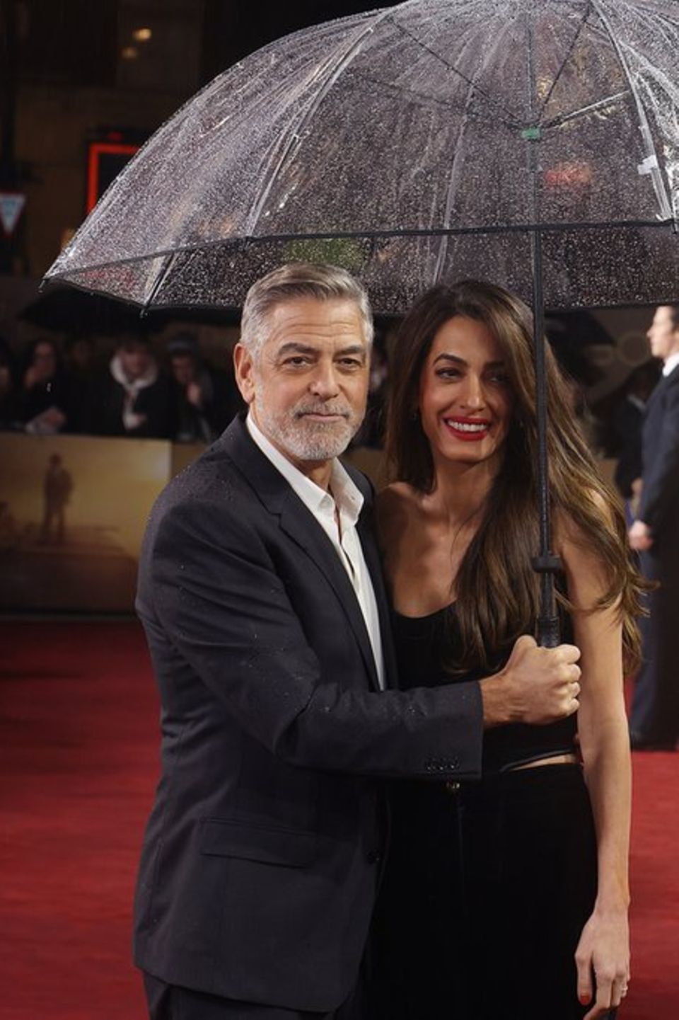 George und Amal Clooney mit Regenschirm in London.